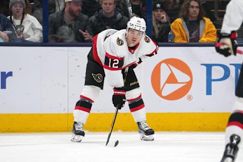 Apr 2, 2023; Columbus, Ohio, USA; Ottawa Senators right wing Alex DeBrincat (12) lines up for a face-off during the second period against the Columbus Blue Jackets at Nationwide Arena. Mandatory Credit: Jason Mowry-USA TODAY Sports