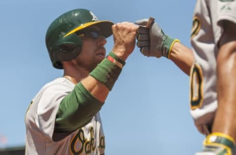 Jul 26, 2015; San Francisco, CA, USA; Oakland Athletics left fielder Ben Zobrist (18) celebrates with shortstop Marcus Semien (10) after scoring against the San Francisco Giants during the fourth inning at AT&T Park. Mandatory Credit: Ed Szczepanski-USA TODAY Sports