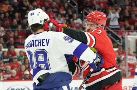 RALEIGH, NC – JANUARY 05: Carolina Hurricanes Defenceman Brett Pesce (22) takes a shot at the head of Tampa Bay Lightning Defenceman Mikhail Sergachev (98) during a game between the Tampa Bay Lightning and the Carolina Hurricanes on January 5, 2020 at the PNC Arena in Raleigh, NC. (Photo by Greg Thompson/Icon Sportswire via Getty Images)