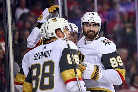 CALGARY, AB – MARCH 10: Vegas Golden Knights Right Wing Alex Tuch (89) smiles as he celebrates a goal on the Calgary Flames by Winger Brandon Pirri (73) with Defenceman Nate Schmidt (88) and Center Cody Eakin (21) during the first period of an NHL game where the Calgary Flames hosted the Vegas Golden Knights on March 10, 2019, at the Scotiabank Saddledome in Calgary, AB. (Photo by Brett Holmes/Icon Sportswire via Getty Images)