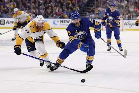 Apr 1, 2022; Buffalo, New York, USA; Nashville Predators defenseman Mattias Ekholm (14) and Buffalo Sabres center Vinnie Hinostroza (29) go after a loose puck during the second period at KeyBank Center. Mandatory Credit: Timothy T. Ludwig-USA TODAY Sports