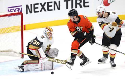 ANAHEIM, CALIFORNIA – MARCH 04: Troy Terry #19 of the Anaheim Ducks leaps to avoid a shot on goal as Laurent Brossoit #39 of the Vegas Golden Knights defends during the third period of a game at Honda Center on March 04, 2022, in Anaheim, California. (Photo by Sean M. Haffey/Getty Images)