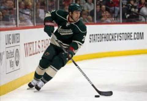 Oct 10, 2013; Saint Paul, MN, USA; Minnesota Wild defenseman Keith Ballard (2) skates with the puck in the first period against the Winnipeg Jets at Xcel Energy Center. Mandatory Credit: Jesse Johnson-USA TODAY Sports