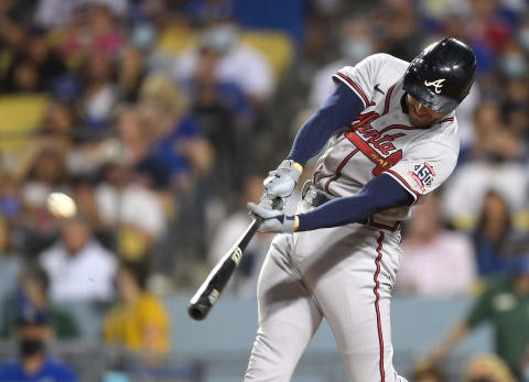 Aug 30, 2021; Los Angeles, California, USA; Atlanta Braves first baseman Freddie Freeman (5) hits a solo home run in the sixth inning of the game against the Los Angeles Dodgers at Dodger Stadium. Mandatory Credit: Jayne Kamin-Oncea-USA TODAY Sports