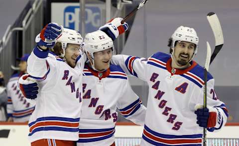 Jan 22, 2021; Pittsburgh, Pennsylvania, USA; New York Rangers defenseman Adam Fox (23) celebrates his goal with New York Rangers left wing Artemi Panarin (10) and left wing Chris Kreider (20) against the Pittsburgh Penguins during the second period at the PPG Paints Arena. Pittsburgh won 4-3 in a shoot-out. Mandatory Credit: Charles LeClaire-USA TODAY Sports