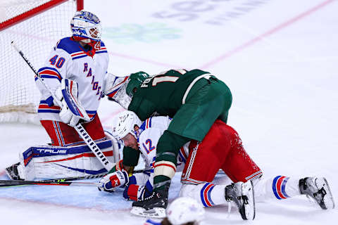 Mar 8, 2022; Saint Paul, Minnesota, USA; Minnesota Wild left wing Marcus Foligno (17) falls on New York Rangers defenseman Patrik Nemeth (12) during the third period at Xcel Energy Center. Mandatory Credit: Harrison Barden-USA TODAY Sports