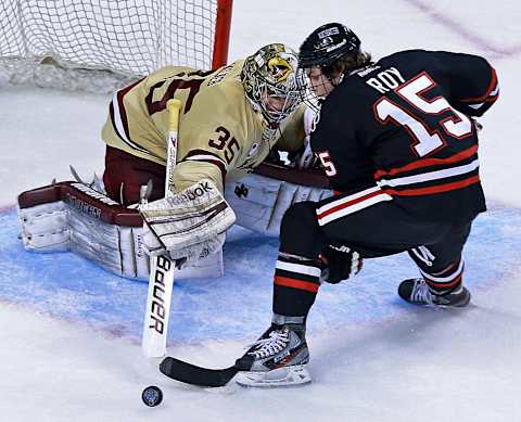 BOSTON – FEBRUARY 11: NU’s Kevin Roy (#15) walked in all alone on BC goalie Parker Milner in the third period, looking to score yet another goal, but this time Milner made a nice stick save to thwart the bid. Boston College and Northeastern University met in the championship game of the Beanpot Tournament at the TD Garden. (Photo by Jim Davis/The Boston Globe via Getty Images)