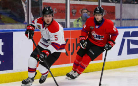 KITCHENER, ONTARIO – MARCH 23: Denton Mateychuk #5 of Team White skates with the puck against Hunter Haight #19 of Team Red in the 2022 CHL/NHL Top Prospects Game at Kitchener Memorial Auditorium on March 23, 2022 in Kitchener, Ontario. (Photo by Chris Tanouye/Getty Images)