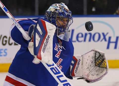 Jan 13, 2015; New York, NY, USA; New York Rangers goalie Henrik Lundqvist (30) makes a save against the New York Islanders during the first period at Madison Square Garden. Mandatory Credit: Adam Hunger-USA TODAY Sports