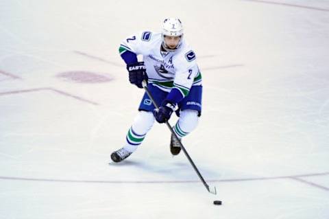 Feb 10, 2016; Glendale, AZ, USA; Vancouver Canucks defenseman Dan Hamhuis (2) carries the puck during the first period against the Arizona Coyotes at Gila River Arena. Mandatory Credit: Matt Kartozian-USA TODAY Sports