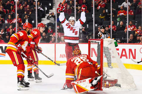 CALGARY, AB – DECEMBER 9: Sebastian Aho #20 of the Carolina Hurricanes celebrates after scoring the game-winning goal against Jacob Markstrom #25 of the Calgary Flames during the overtime period of an NHL game at Scotiabank Saddledome on December 9, 2021, in Calgary, Alberta, Canada. (Photo by Derek Leung/Getty Images)