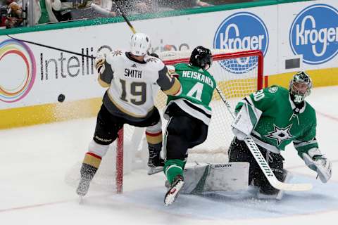 DALLAS, TEXAS – DECEMBER 13: Ben Bishop #30 of the Dallas Stars blocks a shot on goal as Miro Heiskanen #4 of the Dallas Stars collides with Reilly Smith #19 of the Vegas Golden Knights in the first overtime period at American Airlines Center on December 13, 2019 in Dallas, Texas. (Photo by Tom Pennington/Getty Images)