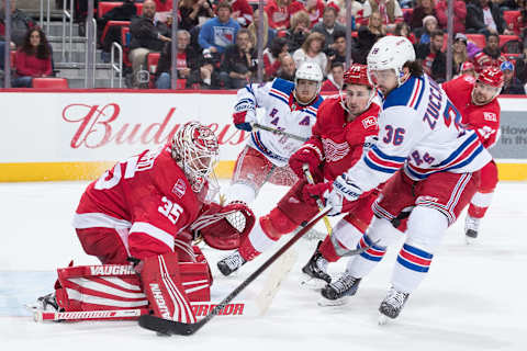 DETROIT, MI – DECEMBER 29: Goaltender Jimmy Howard #35 of the Detroit Red Wings makes a save against Mats Zuccarello #36 of the New York Rangers as Dylan Larkin #71 of the Wings defends during an NHL game at Little Caesars Arena on December 29, 2017 in Detroit, Michigan. (Photo by Dave Reginek/NHLI via Getty Images)