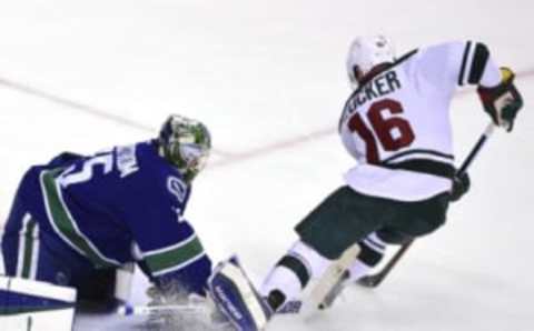 Feb 15, 2016; Vancouver, British Columbia, CAN; Vancouver Canucks goaltender Jacob Markstrom (25) defends against Minnesota Wild forward Jason Zucker (16) during the second period at Rogers Arena. Mandatory Credit: Anne-Marie Sorvin-USA TODAY Sports