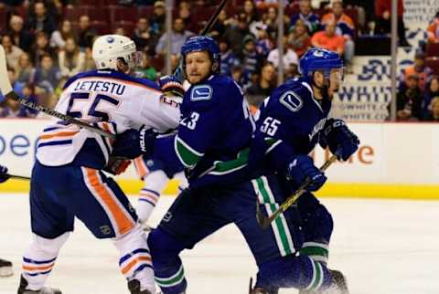 Dec 26, 2015; Vancouver, British Columbia, CAN; Vancouver Canucks defenseman Alexander Edler (23) defends against Edmonton Oilers forward Mark Letestu (55) during the first period at Rogers Arena. Mandatory Credit: Anne-Marie Sorvin-USA TODAY Sports