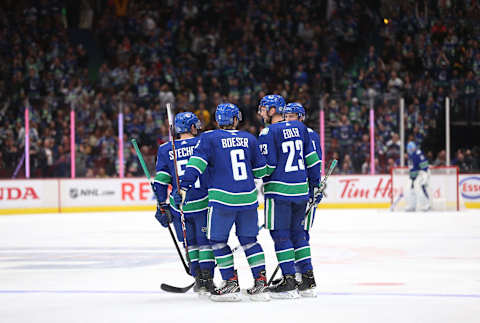 Alexander Edler #23 of the Vancouver Canucks celebrates a goal with teammates. (Photo by Ben Nelms/Getty Images)