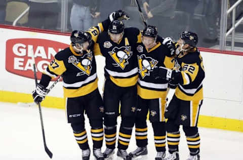 NHL Power Rankings: Pittsburgh Penguins players Sidney Crosby (87) and Evgeni Malkin (71) and Patric Hornqvist (72) and Carl Hagelin (62) celebrate after a game winning power play goal by Malkin in overtime against the Montreal Canadiens at the PPG PAINTS Arena. The Pens won 4-3 in overtime. Mandatory Credit: Charles LeClaire-USA TODAY Sports