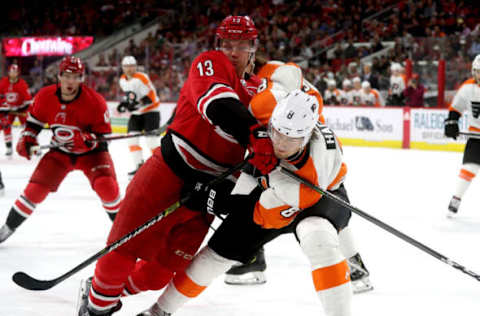 RALEIGH, NC – MARCH 30: Warren Foegele #13 of the Carolina Hurricanes and Robert Hagg #8 of the Philadelphia Flyers battle in the corner for a loose puck during an NHL game on March 30, 2019 at PNC Arena in Raleigh, North Carolina. (Photo by Gregg Forwerck/NHLI via Getty Images)