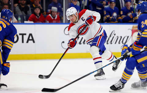 Mar 27, 2023; Buffalo, New York, USA; Montreal Canadiens center Nick Suzuki (14) takes a shot on goal during the third period against the Buffalo Sabres at KeyBank Center. Mandatory Credit: Timothy T. Ludwig-USA TODAY Sports