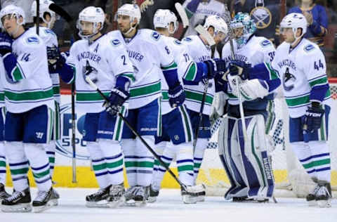 Feb 10, 2016; Glendale, AZ, USA; The Vancouver Canucks celebrate after beating the Arizona Coyotes 2-1 at Gila River Arena. Mandatory Credit: Matt Kartozian-USA TODAY Sports