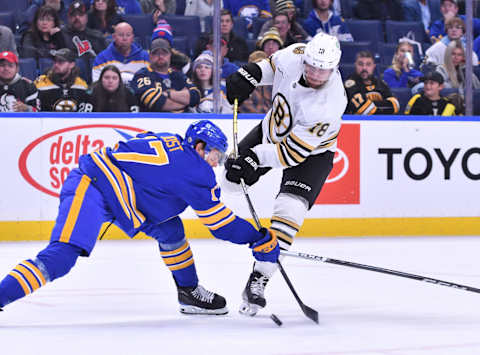 Nov 14, 2023; Buffalo, New York, USA; Boston Bruins center Pavel Zacha (18) tries to get the puck past Buffalo Sabres center Tyson Jost (17) in the third period at KeyBank Center. Mandatory Credit: Mark Konezny-USA TODAY Sports