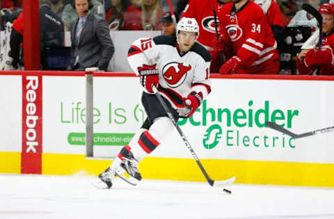 Dec 26, 2015; Raleigh, NC, USA; New Jersey Devils forward Tuomo Ruutu (15) skates with the puck against the Carolina Hurricanes at PNC Arena. The Carolina Hurricanes defeated the New Jersey Devils 3-1. Mandatory Credit: James Guillory-USA TODAY Sports