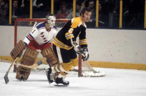 NEW YORK, NY – 1971: Ken Hodge #8 of the Boston Bruins skates on the ice as goalie Ed Giacomin #1 of the New York Rangers tries to track down the puck during their game circa 1971 at the Madison Square Garden in New York, New York. (Photo by Melchior DiGiacomo/Getty Images)