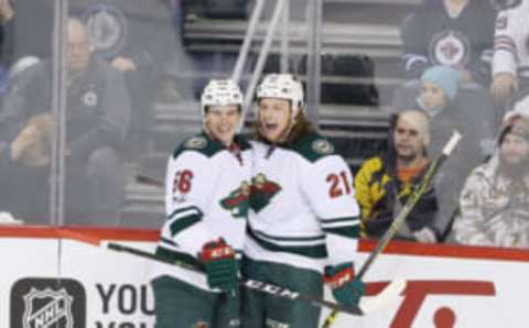 Feb 28, 2017; Winnipeg, Manitoba, CAN; Minnesota Wild center Ryan White (21) celebrates his goal with teammate Minnesota Wild left wing Erik Haula (56) after he scores on Winnipeg Jets goalie Connor Hellebuyck (37) during the second period at MTS Centre. Mandatory Credit: Bruce Fedyck-USA TODAY Sports