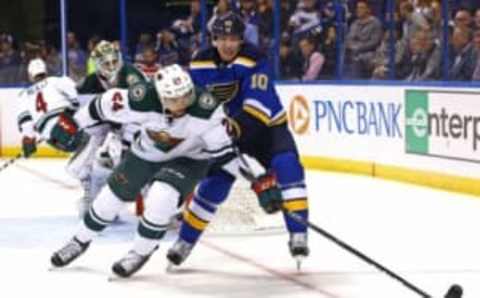 Oct 13, 2016; St. Louis, MO, USA; Minnesota Wild defenseman Matt Dumba (24) and St. Louis Blues right wing Scottie Upshall (10) battle for position for a loose puck in the corner during the second period at Scottrade Center. Mandatory Credit: Billy Hurst-USA TODAY Sports