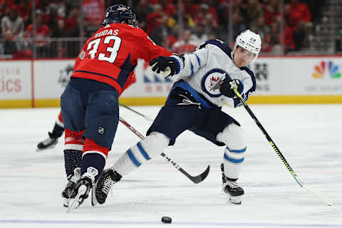 WASHINGTON, DC – FEBRUARY 25: Jack Roslovic #28 of the Winnipeg Jets is checked by Radko Gudas #33 of the Washington Capitals during the first period at Capital One Arena on February 25, 2020 in Washington, DC. (Photo by Patrick Smith/Getty Images)