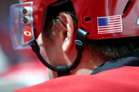 RALEIGH, NC – NOVEMBER 10: A member of the Carolina Hurricanes is pictured on the bench with a US flag decal on his helmet to commemorate Veterans Day during an NHL game against the Anaheim Ducks on November 10, 2016 at PNC Arena in Raleigh, North Carolina. (Photo by Gregg Forwerck/NHLI via Getty Images)