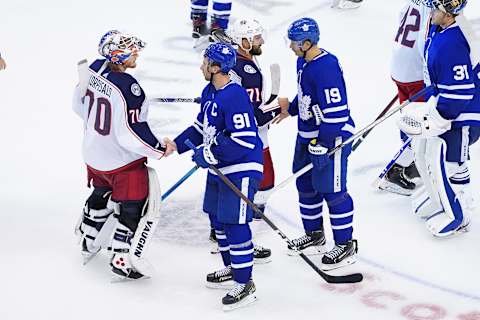 TORONTO, ONTARIO – AUGUST 09: Joonas Korpisalo #70 and Nick Foligno #71 of the Columbus Blue Jackets shake hands with John Tavares #91 and Jason Spezza #19 of the Toronto Maple Leafs   (Photo by Andre Ringuette/Freestyle Photo/Getty Images)