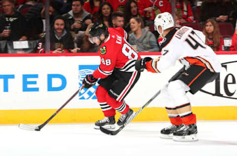 CHICAGO, IL – OCTOBER 23: Patrick Kane #88 of the Chicago Blackhawks grabs the puck ahead of Hampus Lindholm #47 of the Anaheim Ducks in the second period at the United Center on October 23, 2018, in Chicago, Illinois. The Chicago Blackhawks defeated the Anaheim Ducks 3-1. (Photo by Chase Agnello-Dean/NHLI via Getty Images)