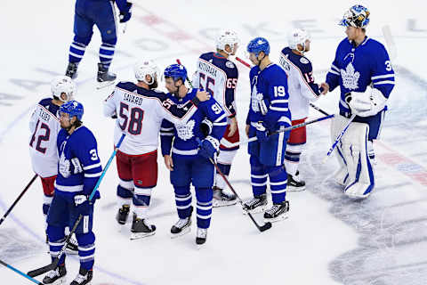 TORONTO, ONTARIO – AUGUST 09:David Savard #58 of the Columbus Blue Jackets shake hands with John Tavares #91 of the Toronto Maple Leafs . (Photo by Andre Ringuette/Freestyle Photo/Getty Images)