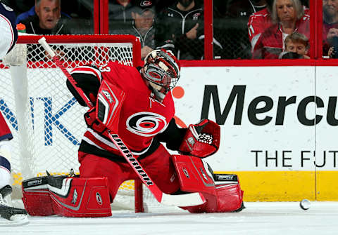 RALEIGH, NC – OCTOBER 10: Scott Darling #33 of the Carolina Hurricanes deflects a Columbus Blue Jackets shot during an NHL game on October 10, 2017 at PNC Arena in Raleigh, North Carolina. (Photo by Gregg Forwerck/NHLI via Getty Images)