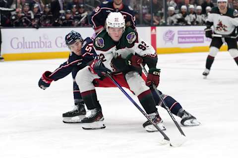 COLUMBUS, OHIO – NOVEMBER 16: Logan Cooley #92 of the Arizona Coyotes skates with the puck against David Jiricek #55 of the Columbus Blue Jackets during the third period at Nationwide Arena on November 16, 2023 in Columbus, Ohio. (Photo by Jason Mowry/Getty Images)