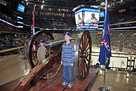 COLUMBUS, OH – JANUARY 26: A pair of young Columbus Blue Jackets fans pose next to the cannon for a photo before the game between the Columbus Blue Jackets and the Chicago Blackhawks on January 26, 2013 at Nationwide Arena in Columbus, Ohio. (Photo by Jamie Sabau/NHLI via Getty Images)