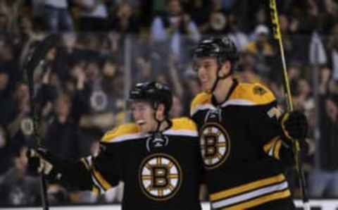 Sep 24, 2015; Boston, MA, USA; Boston Bruins center Austin Czarnik (61) celebrates a goal with defenseman Brandon Carlo (73) during the third period again the New York Rangers at TD Garden. Mandatory Credit: Bob DeChiara-USA TODAY Sports