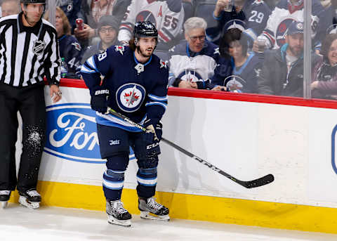 WINNIPEG, MB – FEBRUARY 16: Nic Petan #19 of the Winnipeg Jets keeps an eye on the play during third period action against the Colorado Avalanche at the Bell MTS Place on February 16, 2018 in Winnipeg, Manitoba, Canada. The Jets defeated the Avs 6-1. (Photo by Jonathan Kozub/NHLI via Getty Images)