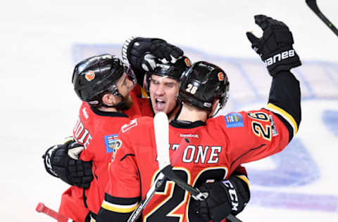 Apr 17, 2017; Calgary, Alberta, CAN; Calgary Flames defenseman TJ Brodie (7) center Mikael Backlund (11) and defenseman Michael Stone (26) celebrates Stone’s second period goal against the Anaheim Ducks in game three of the first round of the 2017 Stanley Cup Playoffs at Scotiabank Saddledome. Mandatory Credit: Candice Ward-USA TODAY Sports