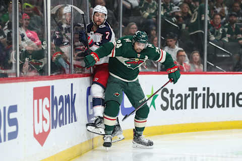 Mar 26, 2022; Saint Paul, Minnesota, USA; Minnesota Wild defenseman Matt Dumba (24) checks Columbus Blue Jackets center Sean Kuraly (7) in the first period at Xcel Energy Center. Mandatory Credit: David Berding-USA TODAY Sports