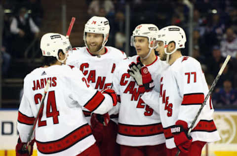 NEW YORK, NEW YORK – APRIL 26: Sebastian Aho #20 of the Carolina Hurricanes (2nd from right) celebrates his third-period goal and his 400th NHL point against the New York Rangers at Madison Square Garden on April 26, 2022, in New York City. The Hurricanes defeated the Rangers 4-3. (Photo by Bruce Bennett/Getty Images)