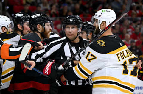 RALEIGH, NORTH CAROLINA – MAY 04: Linesman Ryan Galloway #82 separates Ian Cole #28 of the Carolina Hurricanes and Nick Foligno #17 of the Boston Bruins during the third period of Game Two of the First Round of the 2022 Stanley Cup Playoffs at PNC Arena on May 04, 2022, in Raleigh, North Carolina. The Hurricanes won 5-2. (Photo by Grant Halverson/Getty Images)