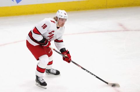 CHICAGO, ILLINOIS – FEBRUARY 04: Ryan Dzingel #18 of the Carolina Hurricanes looks to pass against the Chicago Blackhawks at the United Center on February 04, 2021 in Chicago, Illinois. The Blackhawks defeated the Hurricanes 6-4. (Photo by Jonathan Daniel/Getty Images)