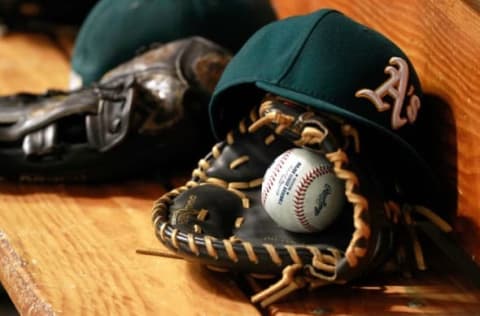 May 23, 2015; St. Petersburg, FL, USA; Oakland Athletics hat, glove and ball lay in the dugout at Tropicana Field. Mandatory Credit: Kim Klement-USA TODAY Sports