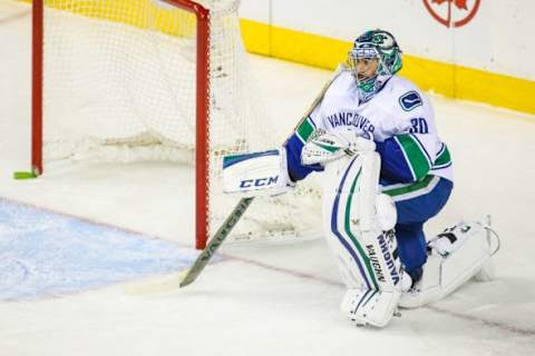 Feb 14, 2015; Calgary, Alberta, CAN; Vancouver Canucks goalie Ryan Miller (30) reacts after a Calgary Flames goal during the second period at Scotiabank Saddledome. Mandatory Credit: Sergei Belski-USA TODAY Sports