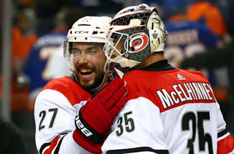 NEW YORK, NEW YORK – APRIL 28: Curtis McElhinney #35 is congratulated by his teammate Justin Faulk #27 after their 2-1 win over the New York Islanders in Game Two of the Eastern Conference Second Round during the 2019 NHL Stanley Cup Playoffs at Barclays Center on April 28, 2019 in New York City. (Photo by Mike Stobe/NHLI via Getty Images)