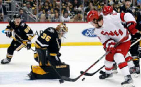 Dec 22, 2022; Pittsburgh, Pennsylvania, USA; Pittsburgh Penguins goaltender Tristan Jarry (35) defends the net against Carolina Hurricanes defenseman Dylan Coghlan (15) during the second period at PPG Paints Arena. Mandatory Credit: Charles LeClaire-USA TODAY Sports