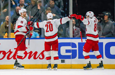 BUFFALO, NY – NOVEMBER 14: Hurricanes players congratulate Carolina Hurricanes defenseman Dougie Hamilton (19) on winning goal during the Carolina Hurricanes and Buffalo Sabres NHL game on November 14, 2019, at KeyBank Center in Buffalo, NY. (Photo by John Crouch/Icon Sportswire via Getty Images)