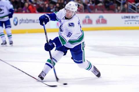 Feb 10, 2016; Glendale, AZ, USA; Vancouver Canucks center Jared McCann (91) shoots the puck during the third period against the Arizona Coyotes at Gila River Arena. Mandatory Credit: Matt Kartozian-USA TODAY Sports